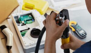 Technician performing EV charger installation services vs standard electrical work setup in a residential garage