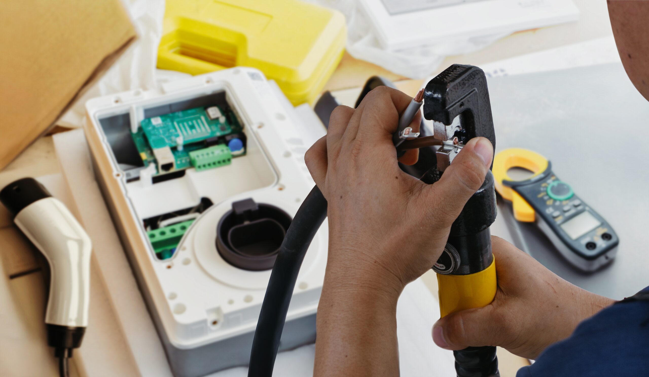 Technician performing EV charger installation services vs standard electrical work setup in a residential garage