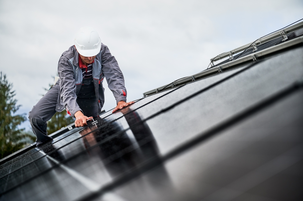 Electrician explaining home generator installation cost and setup requirements to homeowners